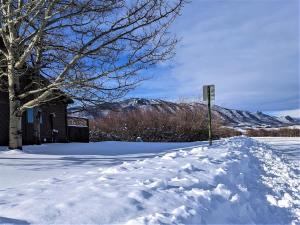 a snow covered street with a sign in front of a building at Putter`s Inn in Red Lodge