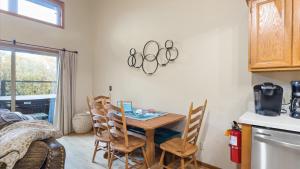 a kitchen with a table and chairs in a room at Putter`s Inn in Red Lodge