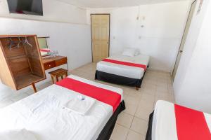 a room with three beds and a desk and a sink at HOTEL LOS CEDROs in Yalsí +3 photos