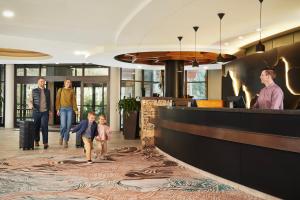 a group of people walking through a lobby at Hilton Whistler Resort & Spa in Whistler +103 photos