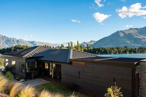 a house with a view of a lake and mountains at Blackwood Lakeview Retreat in Queenstown