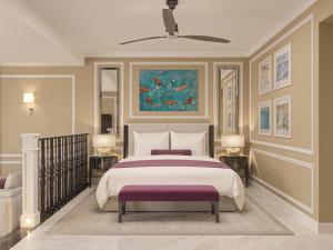 a bedroom with a bed and a painting on the wall at The Grand Resort Rarotonga - Adults Only in Rarotonga +57 photos