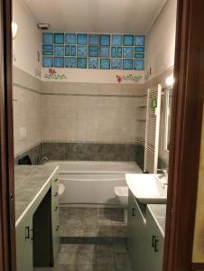 a bathroom with a tub and a toilet and a sink at Residence Future in Cologno Monzese