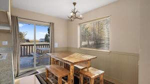 a dining room with a table and chairs and a window at Sans Souci Cabin in Red Lodge