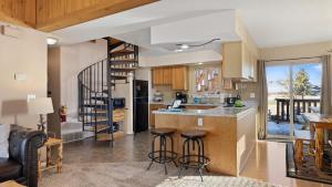 a kitchen with a counter and some bar stools at Sans Souci Cabin in Red Lodge