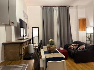 a living room with a couch and a table at Fly City châtelet in Châtelet