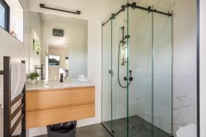 a bathroom with a glass shower and a sink at Blackwood Lakeview Retreat in Queenstown +44 photos