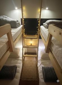 a room with two bunk beds and a mirror at MACARA Guesthouse in Nichinan
