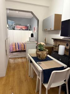 a kitchen with a table and a room with a bed at Fly City châtelet in Châtelet +26 photos