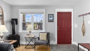 a living room with a red door and a chair at Alpine Adventure in Red Lodge