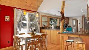 a kitchen with a table and some chairs in a room at Chickadee Chalet in Red Lodge