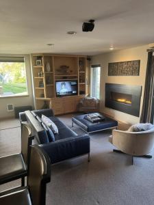 a living room with a couch and a tv at Sanctuary on Snow Creek in Sun Valley