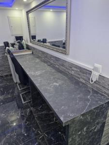 a long counter with a mirror in a waiting room at Beautiful Apartment in Büdingen in Büdingen