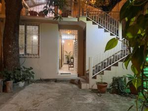 a hallway of a house with stairs and plants at Katún boutique hotel in Flores
