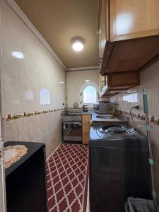 a kitchen with a stove and a sink in it at Classic Seaview in Alexandria