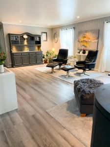 a living room with chairs and a couch and a table at Ditt feriehjem! in Kristiansand
