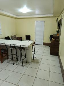 a living room with tables and chairs and a couch at Casa de 1 quarto in Torres