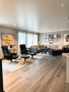 a large living room with chairs and a couch at Ditt feriehjem! in Kristiansand