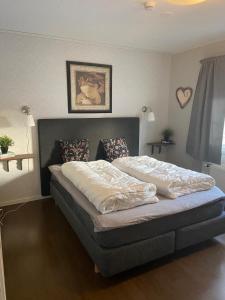 a bedroom with a bed in a room at Ditt feriehjem! in Kristiansand +23 photos
