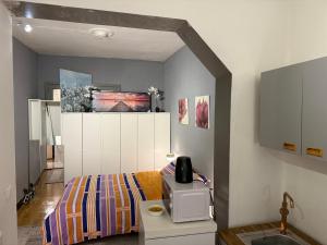a bedroom with a bed and a microwave on a table at Fly City châtelet in Châtelet