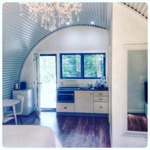 a kitchen with a chandelier and a kitchen with a sink at Romantic Couples Retreat in Mount Tamborine