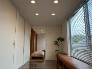 a room with a large window with a bed in it at Urara Holiday in Sumoto