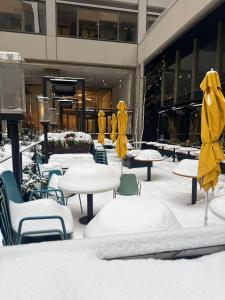a group of tables and chairs covered in snow at FIFA CENTRAL TORONTO-DIRECT TO BMO FIELD-Live Game Atmosphere-Free Wifi in Toronto