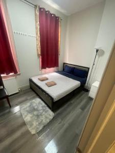 a bedroom with a bed and a red window at FIFA CENTRAL TORONTO-DIRECT TO BMO FIELD-Live Game Atmosphere-Free Wifi in Toronto