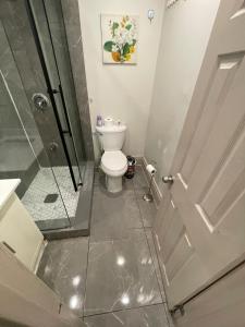 a bathroom with a toilet and a glass shower at FIFA CENTRAL TORONTO-DIRECT TO BMO FIELD-Live Game Atmosphere-Free Wifi in Toronto