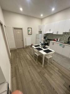 a kitchen with white cabinets and a table in it at FIFA CENTRAL TORONTO-DIRECT TO BMO FIELD-Live Game Atmosphere-Free Wifi in Toronto +2 photos