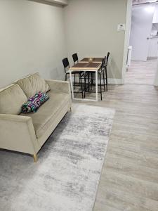 a living room with a couch and a table at FIFA CENTRAL TORONTO-DIRECT TO BMO FIELD-Live Game Atmosphere-Free Wifi in Toronto