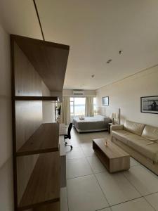 a large living room with a couch and a bed at The One DownTown Costanera in Asunción +5 photos