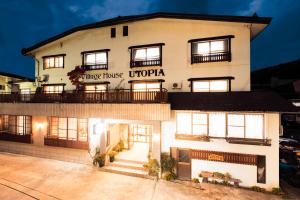 a large white building with a sign on it at Nozawa Onsen Utopia in Nozawa Onsen