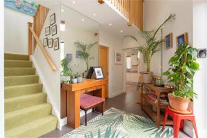a home office with a desk and potted plants at Spectacular 2 Bedroom Apartment with Sunny Garden & Terrace in Dublin