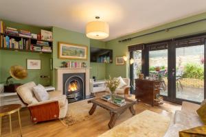 a living room with a fireplace and a table at Spectacular 2 Bedroom Apartment with Sunny Garden & Terrace in Dublin