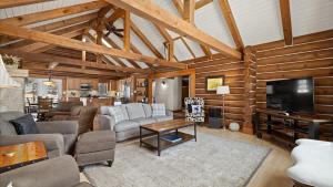 a living room with a couch and a tv at Grizzly Peak Cabin in Red Lodge
