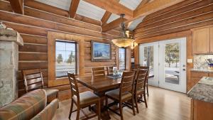 a dining room with wooden walls and a table and chairs at Grizzly Peak Cabin in Red Lodge