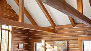 a room with wooden ceilings and windows in a house at Grizzly Peak Cabin in Red Lodge