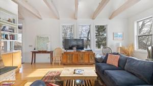 a living room with a couch and a tv at Mountain Treetop in Red Lodge