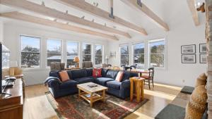 a living room with a blue couch and a table at Mountain Treetop in Red Lodge