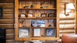 a wooden wall with pictures in a room at Rendezvous Lodge in Red Lodge