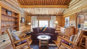 a living room with a couch and chairs in a cabin at Rendezvous Lodge in Red Lodge