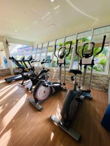 a group of exercise bikes in a room with windows at Baan Bangrak Residence in Trang