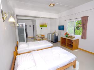a hospital room with two beds and a table at Baan Bangrak Residence in Trang