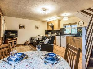 a kitchen and a living room with a table and chairs at Yarlington Mill in Ledbury