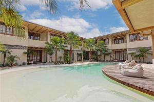 a swimming pool in front of a building at Kumbara Oasis Lombok in Kuta Lombok