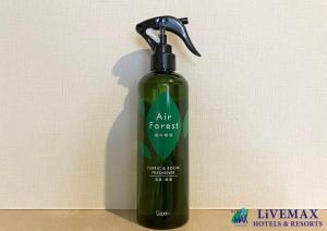 a green bottle of air freshener sitting next to a wall at HOTEL LiVEMAX BUDGET Chofu-Ekimae in Chofu +7 photos