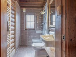 a bathroom with two toilets and a sink at im Brixental II in Wörgl +15 photos