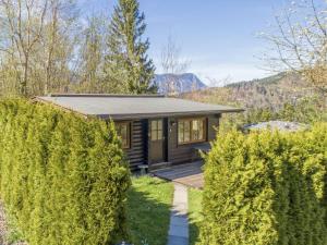 a tiny house in the mountains with a fence at im Brixental II in Wörgl