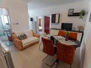 a living room with a table and a couch at Apartments and rooms by the sea Palit, Rab - 5044 in Rab